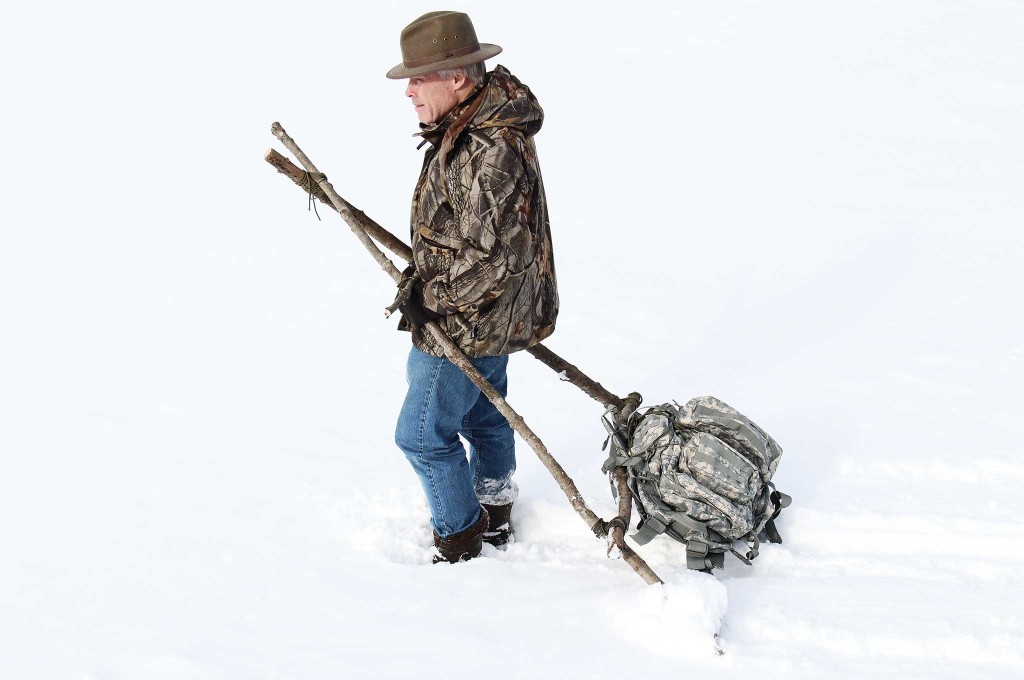 The author tests his finished travois with a pack attached to simulate the load. A travois can be a lifesaver when used to transport an injured companion.
