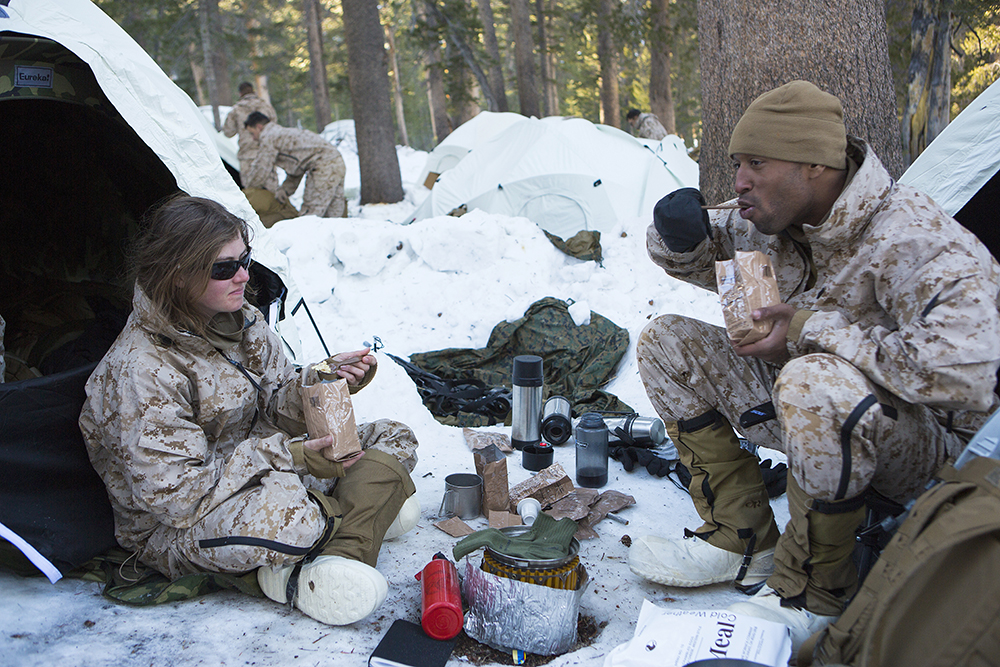 U.S. Marines with Combat Logistics Battalion 26, 2nd Marine Logistics Group, eat their cold weather Meals Ready to Eat, used to sustain an individual during operations occurring under arctic conditions, at the U.S. Marine Corps Mountain Warfare Training Center (MWTC) Bridgeport, Calif., Jan. 24, 2015. MWTC trains Marines across the warfighting functions for operations in mountainous, high altitude, and cold weather environments in order to enhance a unit's ability to shoot, move, communicate, sustain, and survive in mountainous regions of the world. (U.S. Marine Corps photo by Sgt. Anthony L. Ortiz/Released)
