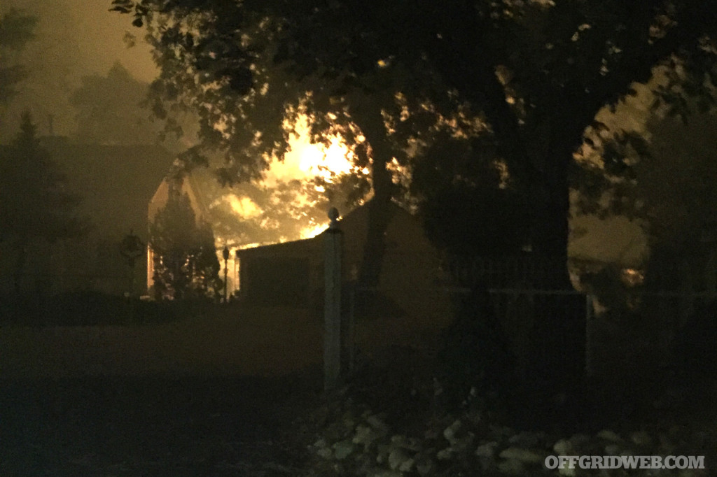 10:26 AM - Fire visible behind homes.