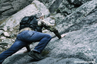 image of a man on a rock scrambling adventure.