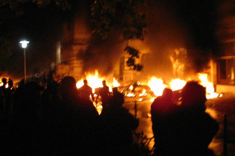 Photo of a riot in a city street.