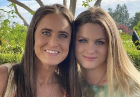 Portrait photo of Holly Courtier and her daughter standing side by side.