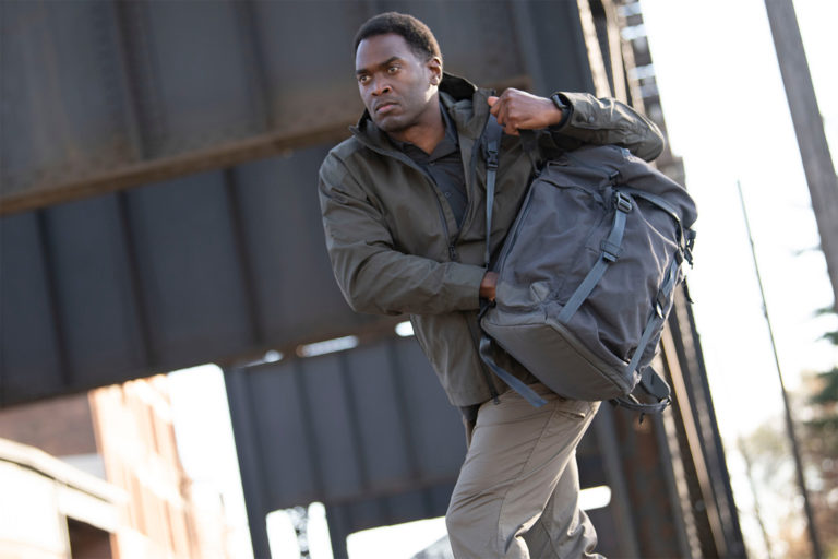 Man reaching into his pack while on the move.
