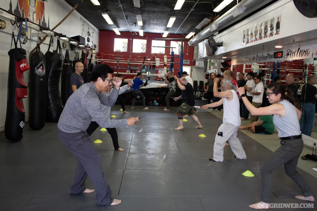 Students in the Tiga Tactics Knife Defense Seminar facing off against each other.