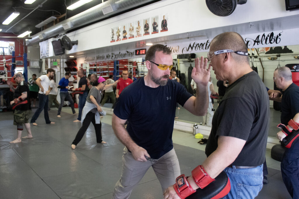 Photo of a students practicing the combat draw during the knife defense seminar.