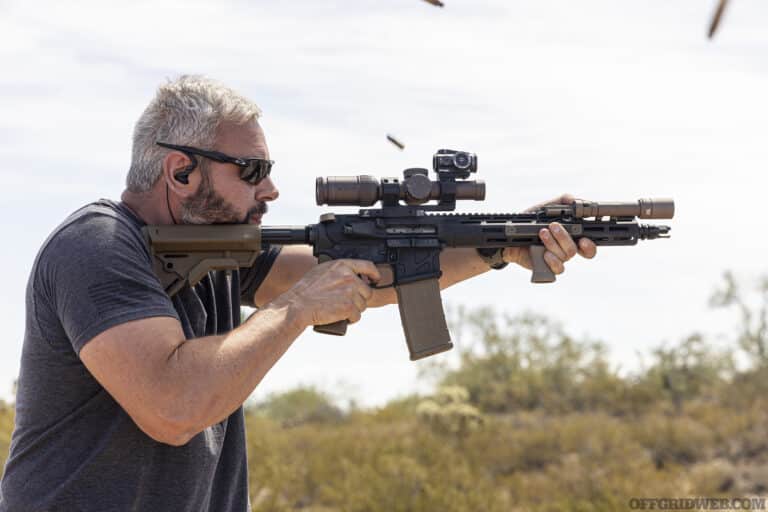 Photo of Tom Marshall firing a modified AR.