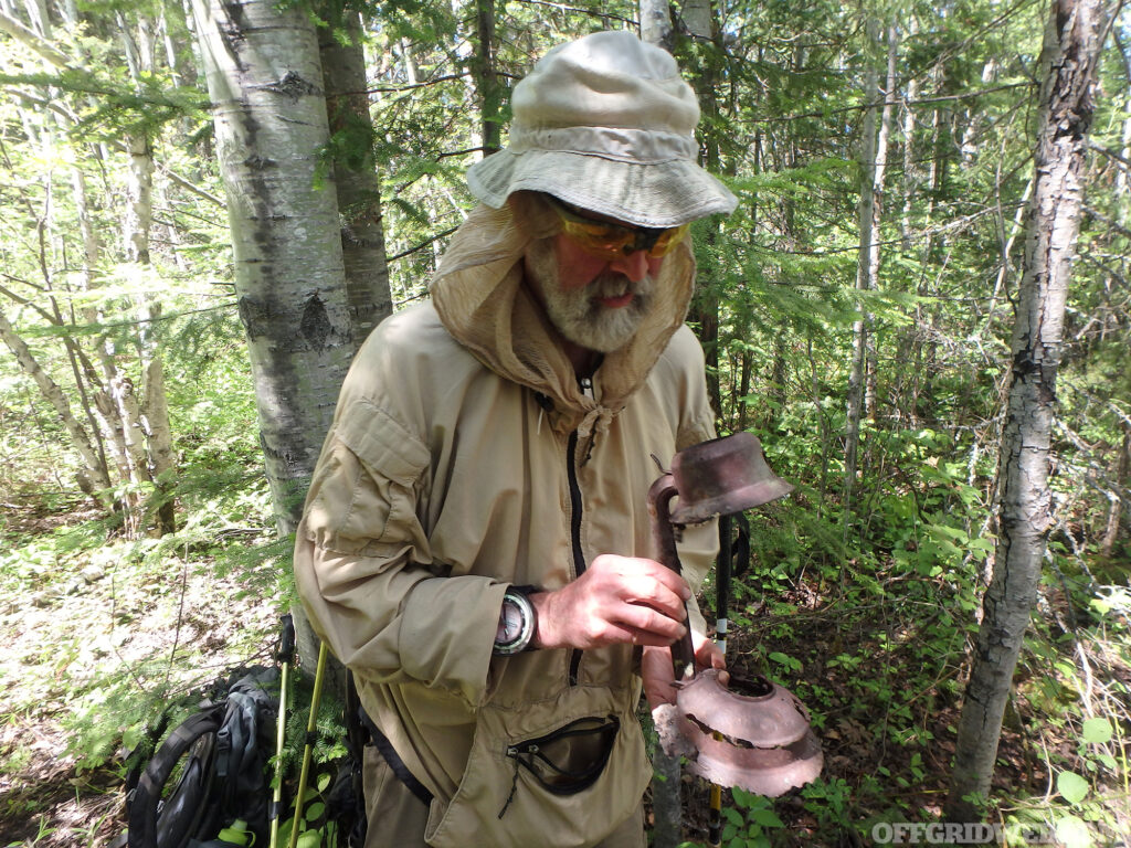 Michael Neiger inspecting an item found on the forest floor.