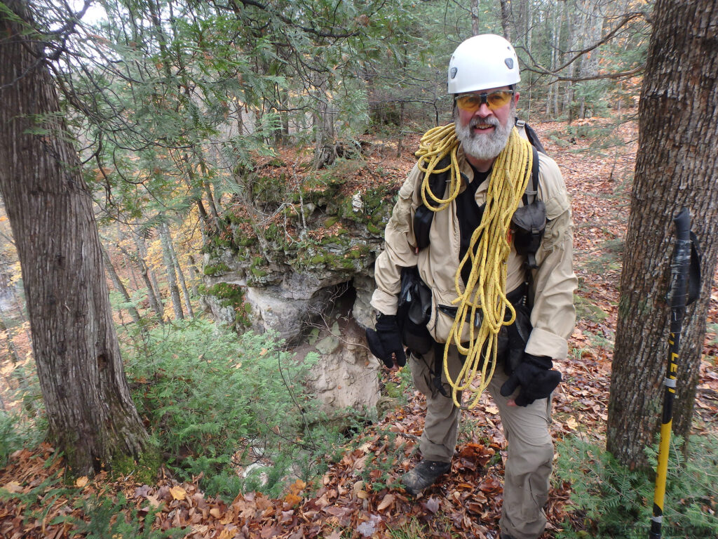 Michael Neiger exploring the area with hard hat and rope.