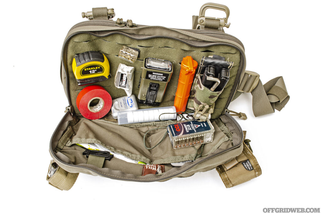 Studio photo of the inside of a chest rig loaded with gear.