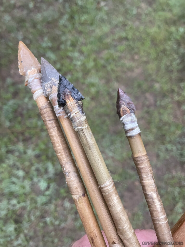 Photo of finished arrowheads attached to shafts of the arrows.