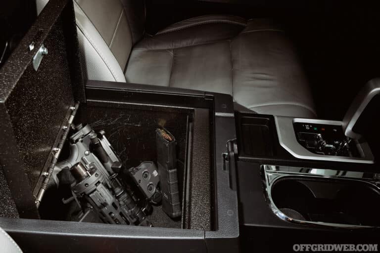 Center console of a vehicle with an ar-15 takedown stored inside.