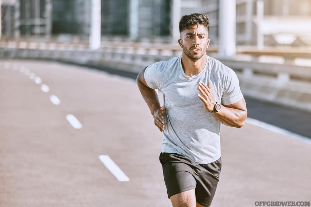 Photo of aman running down a road during the day.