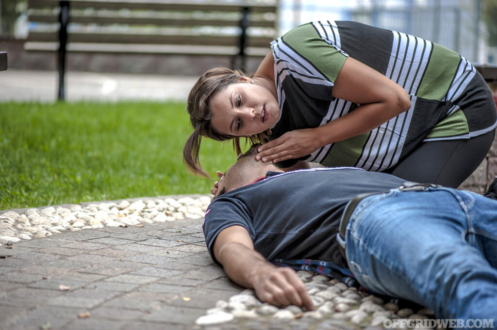 A girl assisting a fainted man.