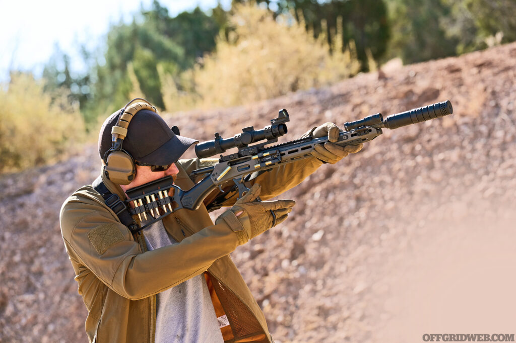 Photo of a man taking aim with a tactical lever gun.