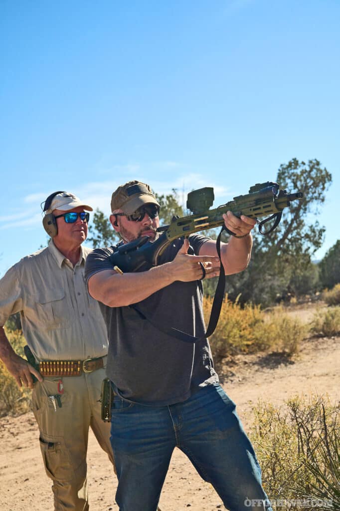 Photo of a man cocking a lever gun.