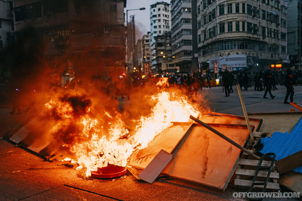 Burning street blockade in Hong Kong, China protesters blocked roads