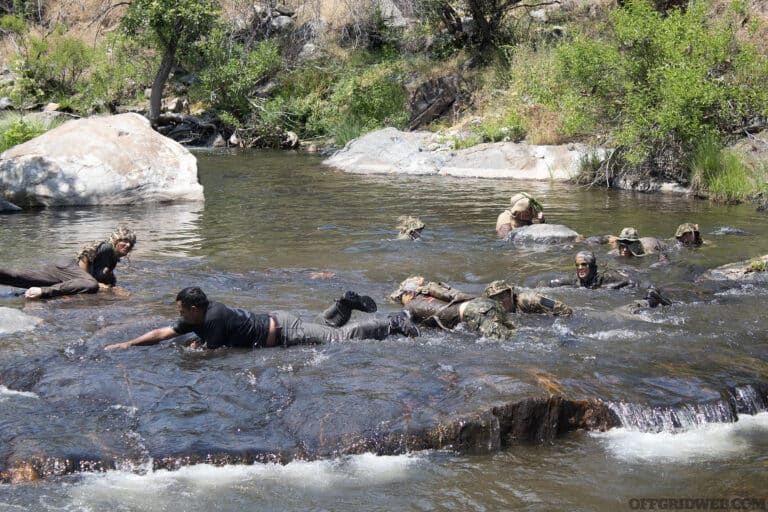 Students of Greenside Training's Camostalk 360 class undergoing "baptism" in a mountain river.