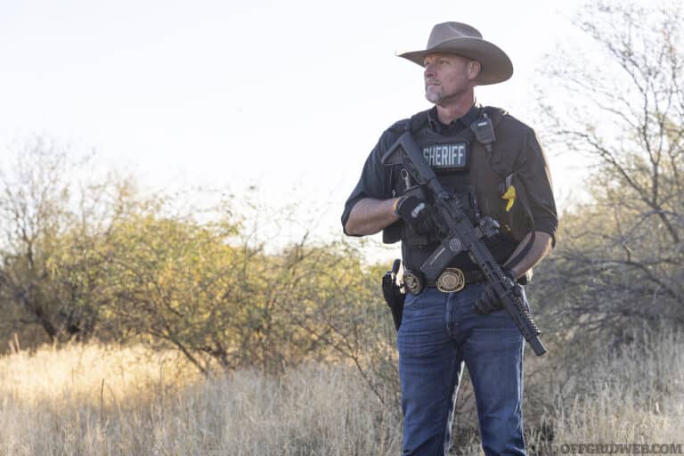 Photo of Mark lamb standing with an AR at the low ready.
