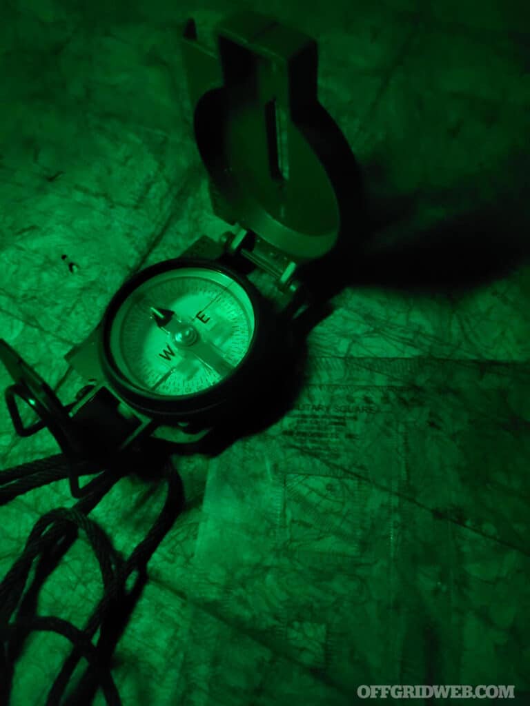 compass and map under green light