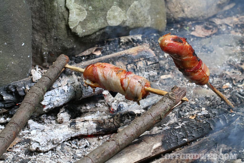 cave man cooking over a fire