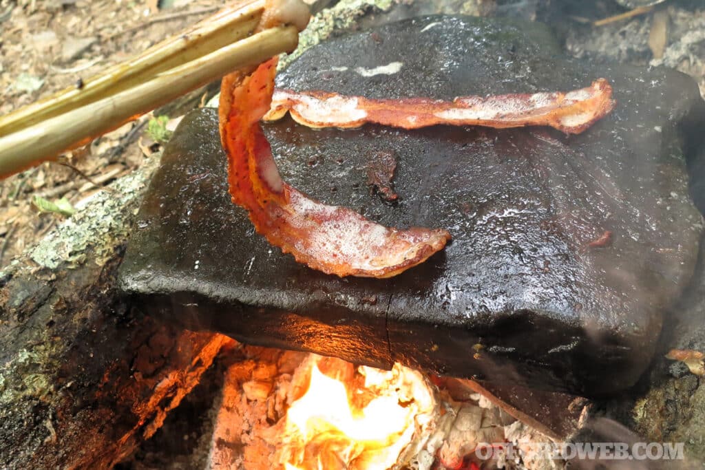 cooking bacon on a stone