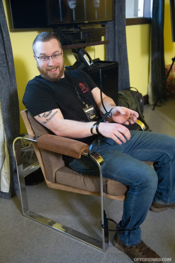 person zip tied to chair