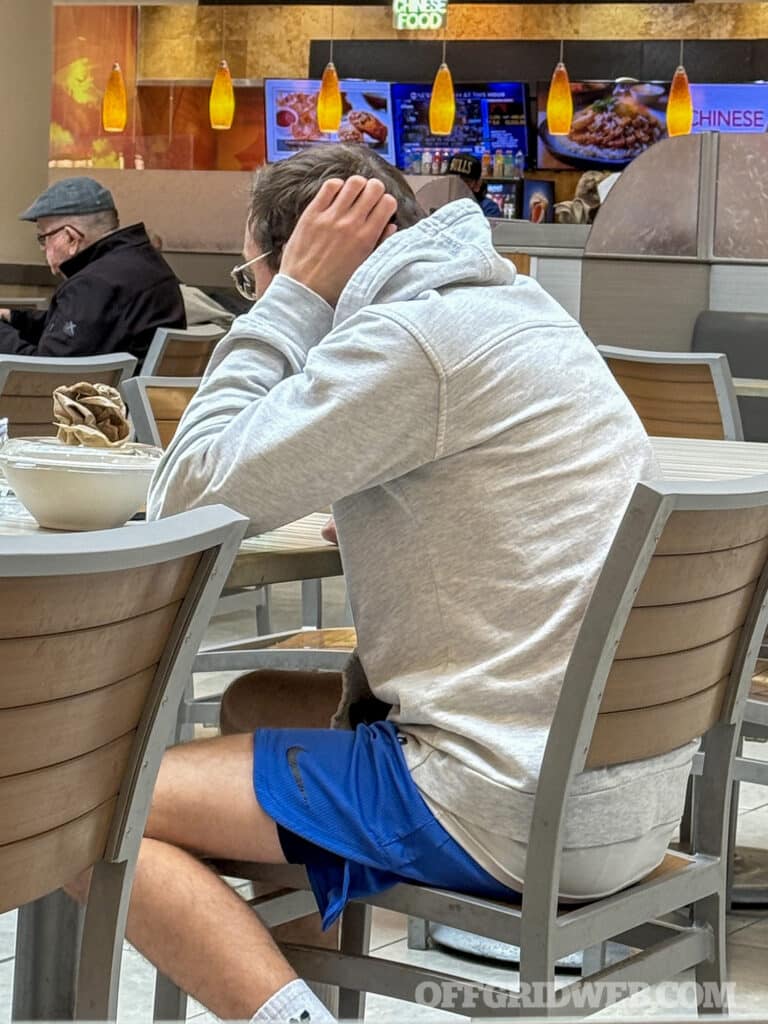 man with hands on neck