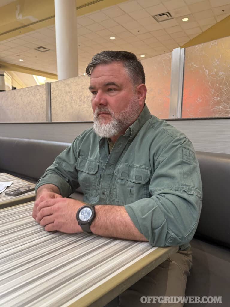 man sitting with hands crossed