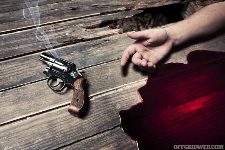 gun with smoke and blood on the floor