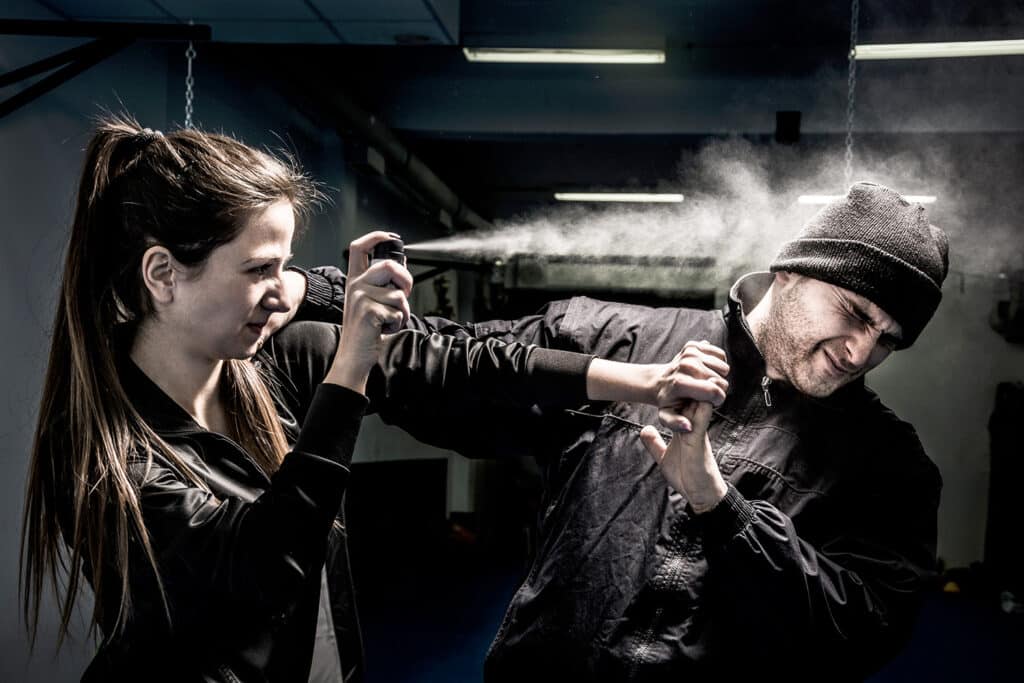 woman using edc pepper spray