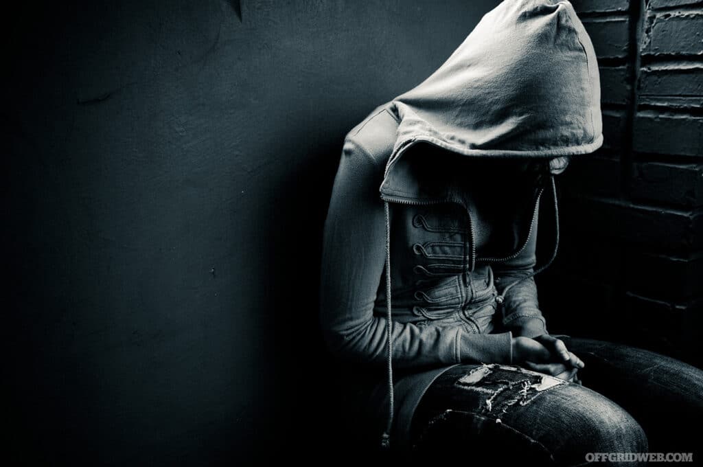 dark image of a person sitting alone