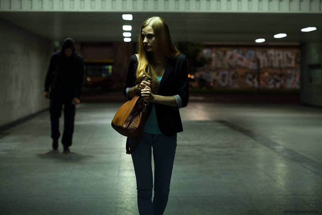 woman being followed in a parking lot