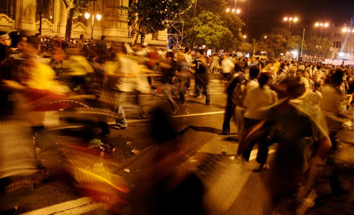 civil unrest at night in a city street