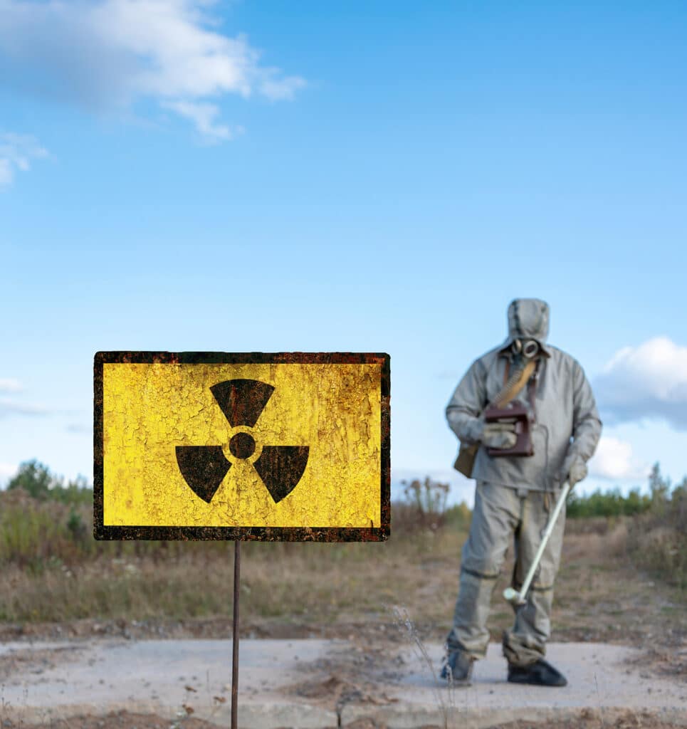 radiation sign man in hazmat suit