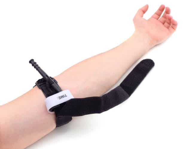 Hemostatic tourniquet imposed on hand isolated on a white background.